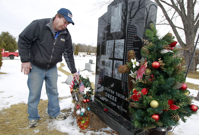 Paul Drees visits the Peshtigo grave of his son, Steven Drees, who was killed in action in Afghanistan in 2009. Steven’s family takes comfort in knowing that as an organ donor, Steven is helping another to live. Image by Rick Wood, 2011. image