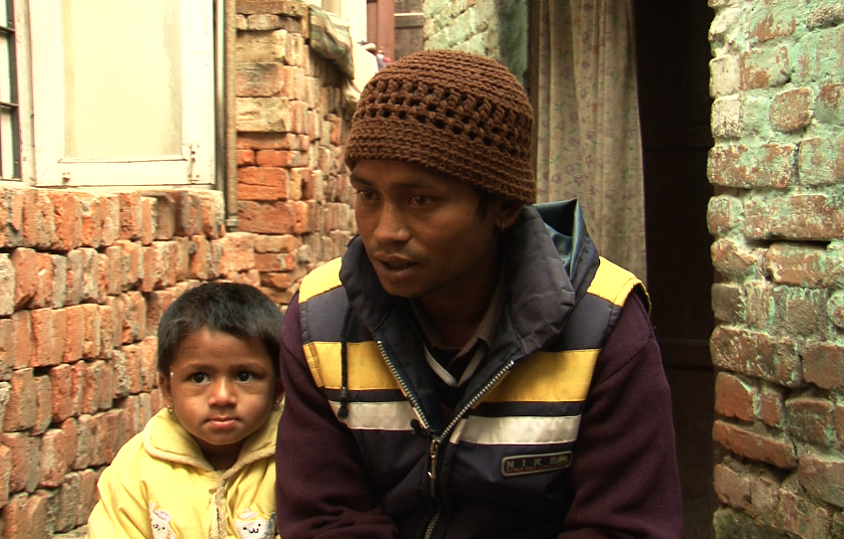 Rajan Kumar Nepali sits with his daughter in his house in Ranibari, Kathmandu. He said his daughter was wrongfully placed for adoption with an American family who were getting ready to take her to the United States. Image by Anup Kaphle. Nepal, 2011. Rajan Kumar Nepali sits with his daughter in his house in Ranibari, Kathmandu. He said his daughter was wrongfully placed for adoption with an American family who were getting ready to take her to the United States. Image by Anup Kaphle. Nepal, 2011.
