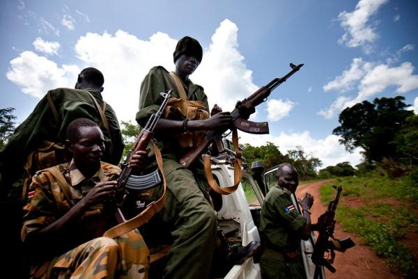 Sudan People's Liberation Army soldiers load their guns before escorting an aid convoy. Image by Trevor Snapp. South Sudan, 2012. Media file: picture10.jpg
