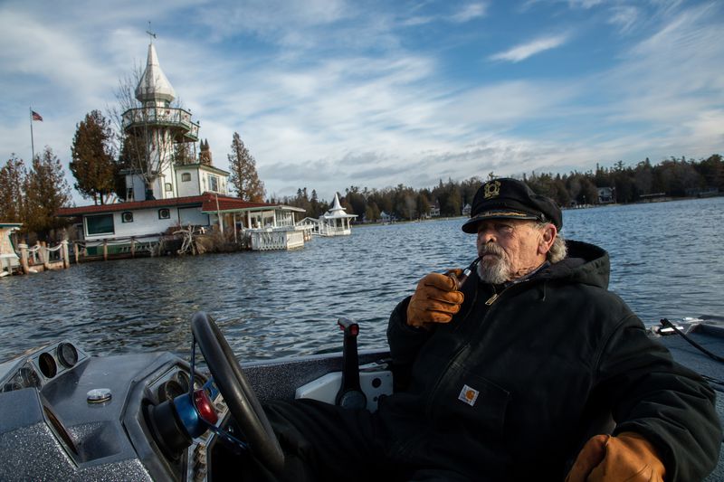 Kenneth "Captain Ken" Kloster Sr. pilots his boat to his home on Dollar Island in Les Cheneaux Islands on Lake Huron in the Upper Peninsula of Michigan on Nov. 23, 2019. He bought the island in 1981 right before record setting high water levels of 1986. Image by Zbigniew Bzdak / Chicago Tribune. United States, 2020. Kenneth "Captain Ken" Kloster Sr. pilots his boat to his home on Dollar Island in Les Cheneaux Islands on Lake Huron in the Upper Peninsula of Michigan on Nov. 23, 2019. He bought the island in 1981 right before record setting high water levels of 1986. Image by Zbigniew Bzdak / Chicago Tribune. United States, 2020.