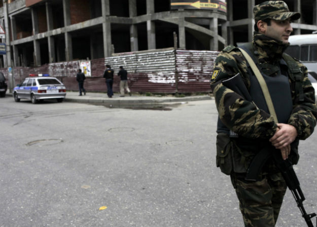 A member of the Dagestani security forces stands guard outside a central building in Makhachkala. The shootings of policemen have grown shockingly common. Image by Diana Markosian. Russia, 2012. Media file: russia_11.jpg