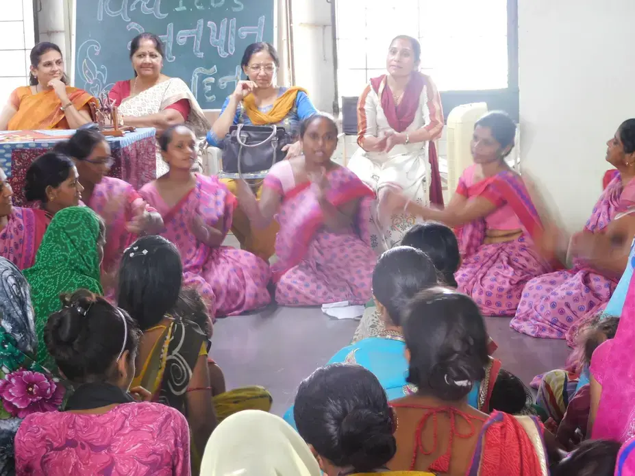 Health workers circle up to perform folklore songs during a Breastfeeding Clinic event run by Manav Sadhna. Image by Ambar Castillo. India, 2017.