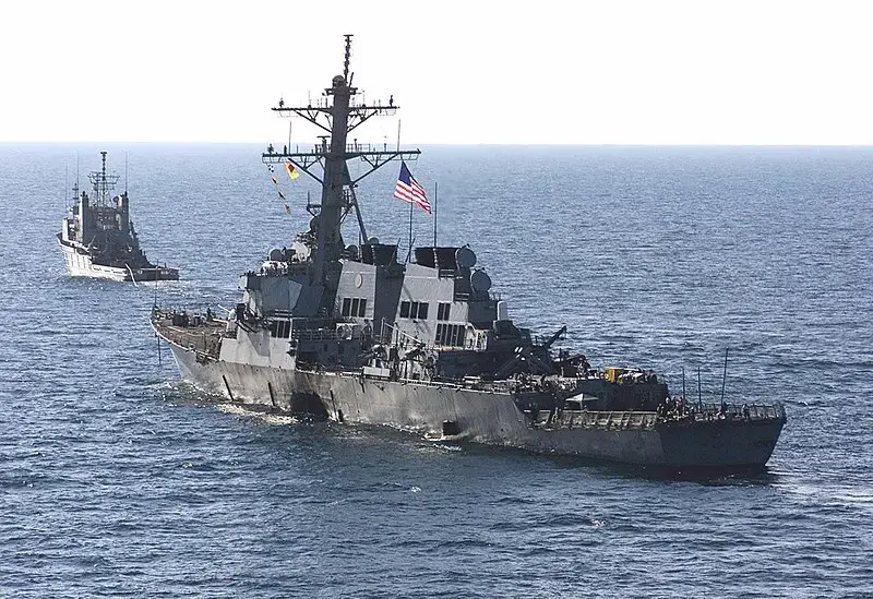 The USS Cole (DDG 67) is towed away from the port city of Aden, Yemen, into open sea by the Military Sealift Command ocean-going tug USNS Catawba (T-ATF 168) on Oct. 29. Image by Sgt. Don L. Maes, U.S. Marine Corps. Yemen, 2000. (Public Domain) The USS Cole (DDG 67) is towed away from the port city of Aden, Yemen, into open sea by the Military Sealift Command ocean-going tug USNS Catawba (T-ATF 168) on Oct. 29. Image by Sgt. Don L. Maes, U.S. Marine Corps. Yemen, 2000. (Public Domain)