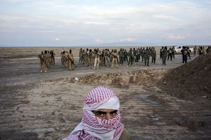 Sunni fighters who oppose the Islamic State take up formation along the front line near the ISIS-controlled village of Haj Ali, south of Mosul. Image by Moises Saman/Magnum Photos. Iraq, 2015. Media file: 160118_mogelson_01-690.jpg