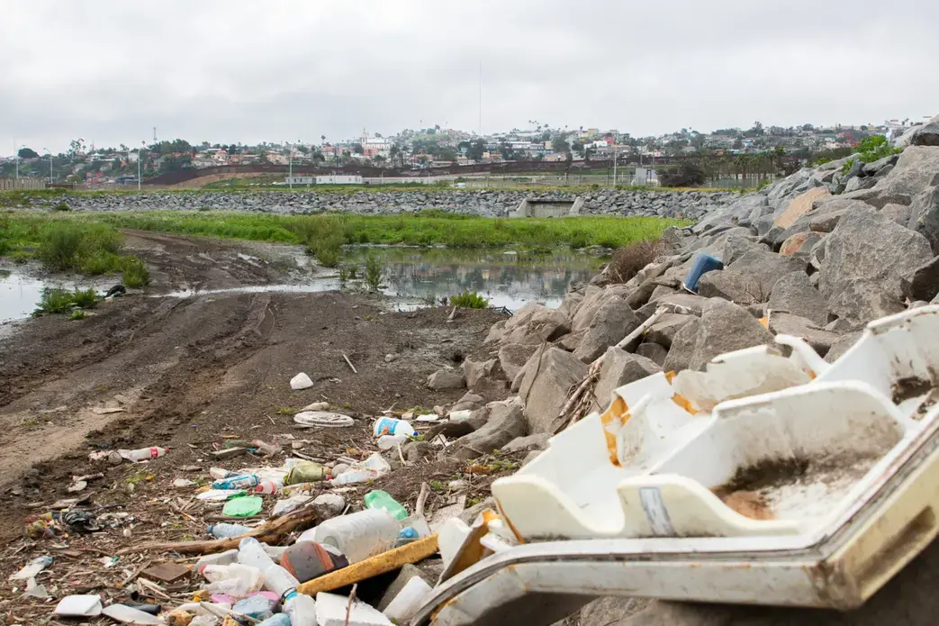 Trash is piled near the U.S.-Mexico border, where sewage from Tijuana flows through. Image by Adriana Heldiz / Voice of San Diego. Trash is piled near the U.S.-Mexico border, where sewage from Tijuana flows through. Image by Adriana Heldiz / Voice of San Diego.