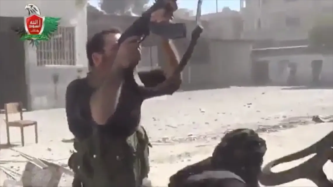Syrian rebel fires on government troops outside Damascus. Image by Reese Erlich. Syria, 2013. Media file: syrian_rebel_shootiing.jpg