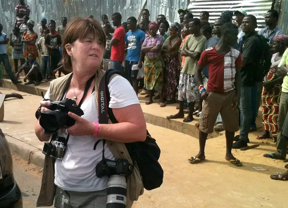 Cheryl Hatch documents the scene of a crime on 72nd Street in Monrovia, Liberia, on Friday, Jan. 9, 2015. Hatch is a photojournalist and visiting professor of journalism in the public interest at Allegheny College. She is in Liberia covering the U.S. military's efforts to help the Liberian government combat Ebola. She is traveling with writer Brian Castner, author of "The Long Walk." Image by Brian Castner. Liberia, 2014. Media file: ar-301119939.jpg