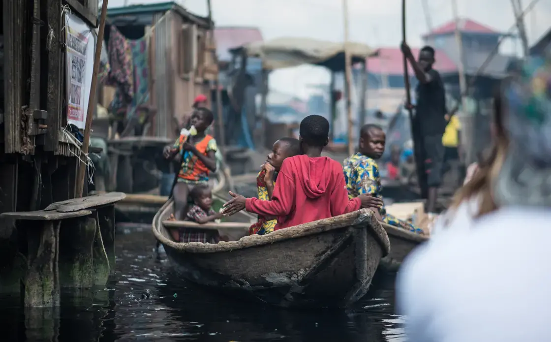 Child rowing a canoe in Makoko. Image by Alucardion / Shutterstock.com. Nigeria, 2019. Child rowing a canoe in Makoko. Image by Alucardion / Shutterstock.com. Nigeria, 2019.