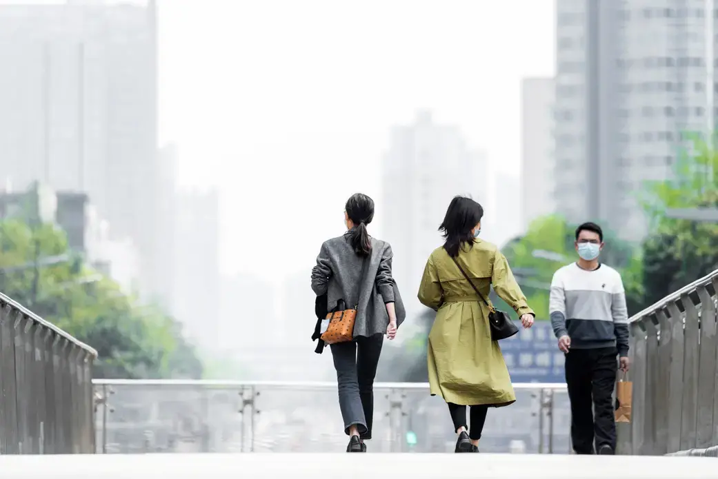 Shopping citizens in China's downtown center wear masks as the city recovers from the COVID-19 epidemic. Image by B.Zhou/Shutterstock. China, 2020