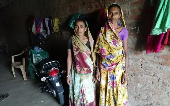 Two women attacked in a witch hunt, Madhuben and Susilaben, stand in an alley in Dahod District, Gujarat, India. Image by Seema Yasmin. India, 2017. Two women attacked in a witch hunt, Madhuben and Susilaben, stand in an alley in Dahod District, Gujarat, India. Image by Seema Yasmin. India, 2017.