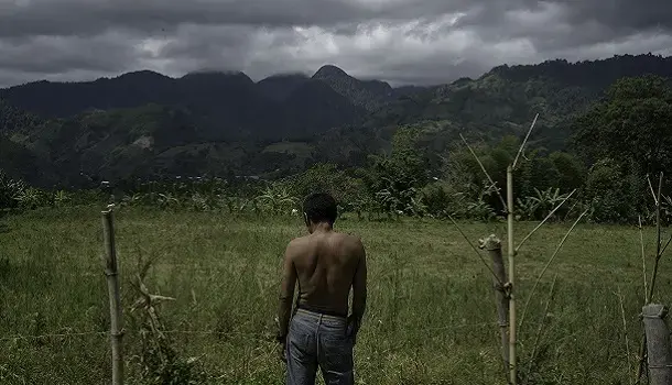 Sanga-Minson, 64, surveys his recently reclaimed land in the Barangay T'konel region. Image by Chien-Chi Chang. Philippines, 2018.