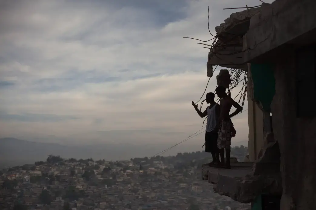 Horlich Florestal (left), 24, and Rosemond Altidon, 22, stand on the edge of their apartment building in Fort National January 9, 2011. Half the building was destroyed in the earthquake, killing many of their neighbors, including two cousins and an aunt. Image Allison Shelley. Haiti, 2011. Horlich Florestal (left), 24, and Rosemond Altidon, 22, stand on the edge of their apartment building in Fort National January 9, 2011. Half the building was destroyed in the earthquake, killing many of their neighbors, including two cousins and an aunt. Image Allison Shelley. Haiti, 2011.