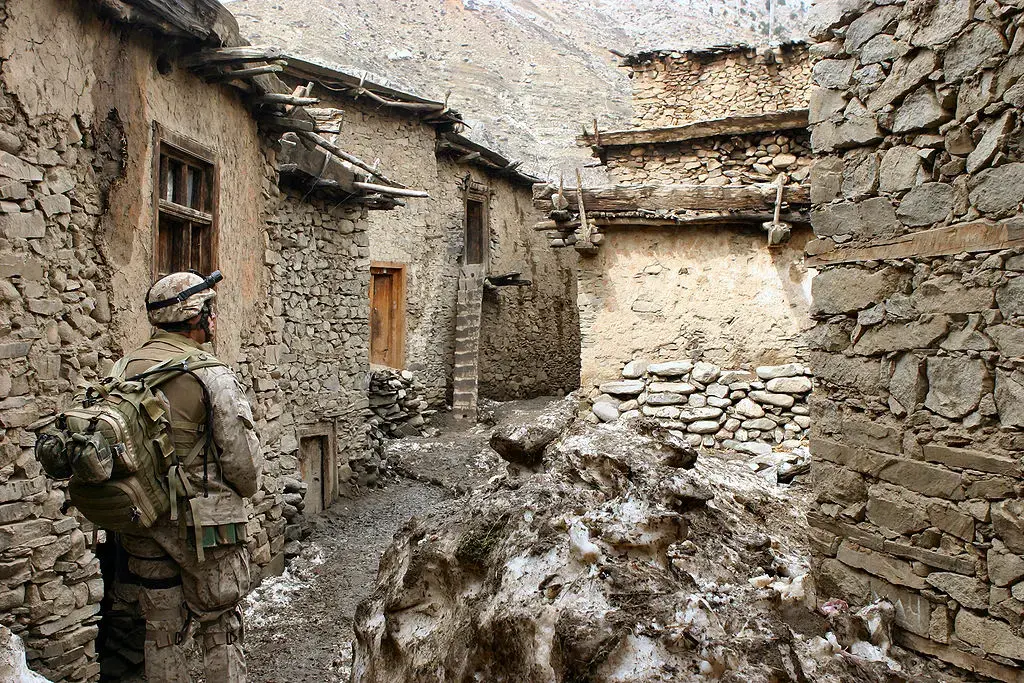 A soldier walks through an alley in the vicinity of Methar Lam. Image by Cpl. James L. Yarboro. Afghanistan, 2005. A soldier walks through an alley in the vicinity of Methar Lam. Image by Cpl. James L. Yarboro. Afghanistan, 2005.