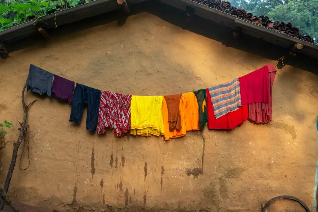 Clothes drying outside a house in the Bastar district. Image by Amitrane / Shutterstock. India, 2016. Clothes drying outside a house in the Bastar district. Image by Amitrane / Shutterstock. India, 2016.