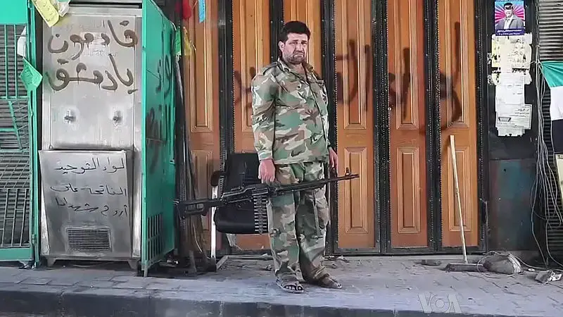 Free Syrian Army soldier in Aleppo. Image by Voice of America News: Scott Bobb. Courtesy of Wikimedia Commons. Syria, 2013. Media file: 800px-free_syrian_army_soldier_with_machine_gun_in_aleppo.jpg