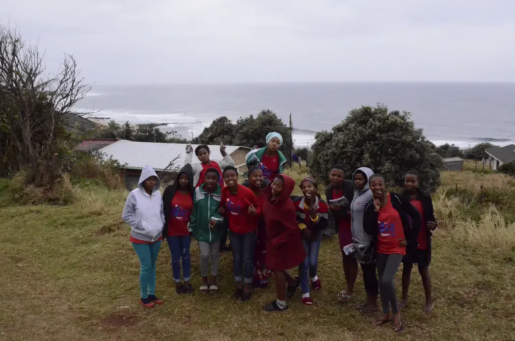 A group of young women activists stand together by the seaside. Image by Amy Maxmen, South Africa, 2016.