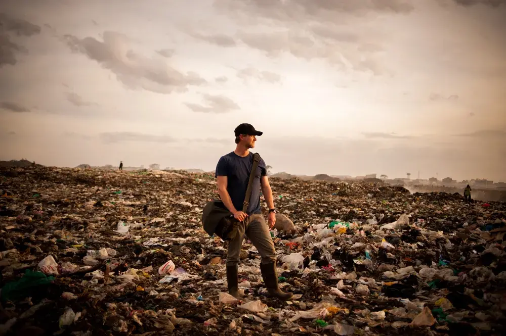 Photographer Micah Albert at the Dandora Dump Site in Nairobi. Kenya, 2013. Media file: micah_dump.jpg