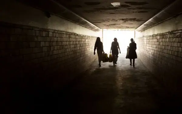 Au pairs walk back to the train after shopping at Loppemarked, a weekend flea market in Gentofte, a wealthy suburb of Copenhagen. The women buy second-hand clothing and gifts to send to their families back home, a common practice of overseas Filipino workers. Image by Allison Shelley. Denmark, 2016.