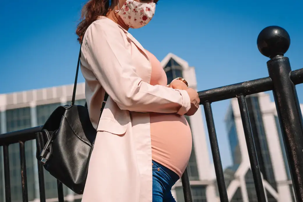 A pregnant woman walks down the street in London. Image by Corpii / Shutterstock. United Kingdom, undated. A pregnant woman walks down the street in London. Image by Corpii / Shutterstock. United Kingdom, undated.
