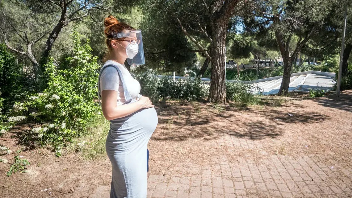 A pregnant woman goes for a walk in a public park in Madrid. Image by JoeLogan / Shutterstock. Spain, 2020. A pregnant woman goes for a walk in a public park in Madrid. Image by JoeLogan / Shutterstock. Spain, 2020.