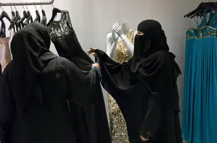 In 2011, the Ministry of Labor ordered shops specializing in cosmetics, abayas, and wedding dresses, along with the women’s sections of department stores, to begin shifting to all-female Saudi sales staffs. The process is called “feminization.” Image by Kate Brooks. Saudi Arabia, 2013 Media file: kate_brooks.jpg