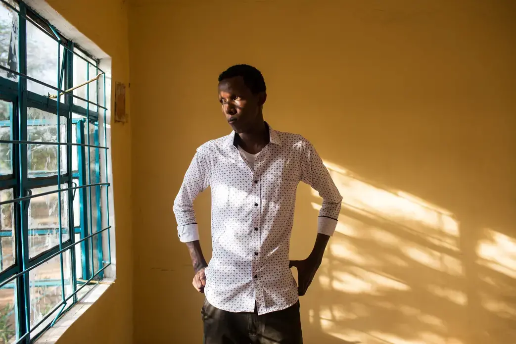 A student teacher poses for a portrait during a class break in Mandera County, Kenya. After Mounting insecurity caused and exodus of up to 60 percent of teaching staff from Mandera, local officials recruited school leavers to help keep the schools open during the crisis. Image by Will Swanson. Kenya, 2015. Media file: pulitzer_banner_meetthejournalist.jpg