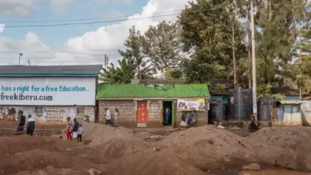 Christ Miracle Church, center, originally built as a public toilet, in Kibera, Nairobi. Image by Peter DiCampo. Kenya, 2018.