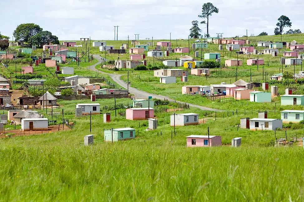 A village of brightly colored Mandela Houses in Zulu Village, Zululand, South Africa. Image by Joseph Sohm / Shutterstock. South Africa, 2019. A village of brightly colored Mandela Houses in Zulu Village, Zululand, South Africa. Image by Joseph Sohm / Shutterstock. South Africa, 2019.