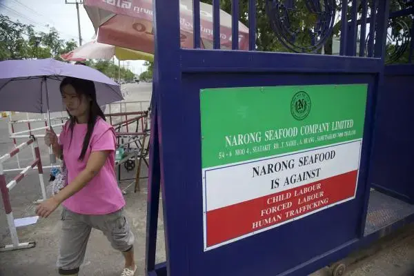 A woman heads home after a day of working in a shrimp peeling factory in Samut Sakhon province, the heart of the processing industry in Thailand. Image by Jason Motlagh. Thailand, 2012. Media file: thailand_seafood.jpg