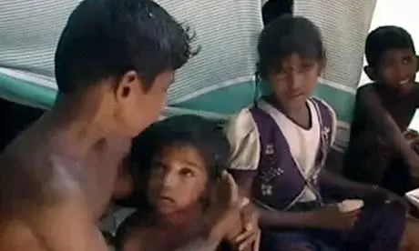 A boy protects his little brother after the artillery fire in a scene from "No Fire Zone." Media file: sri-lanka-brothers-001.jpg