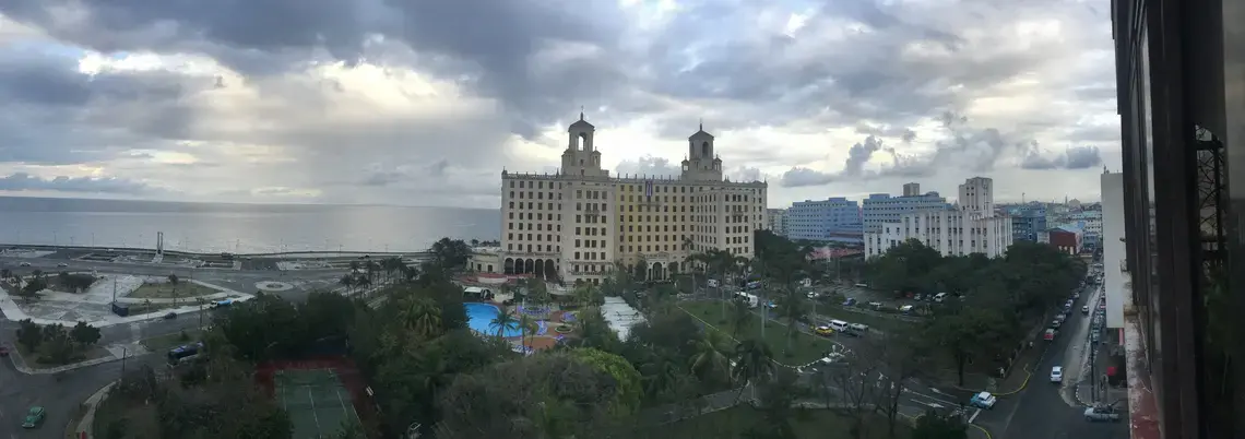 Three aspects of Havana's skyline meet on a cloudy day: the Malecón, Vedado, and Havana Vieja. Image by Esohe Osabuohien. Cuba, 2018. Three aspects of Havana's skyline meet on a cloudy day: the Malecón, Vedado, and Havana Vieja. Image by Esohe Osabuohien. Cuba, 2018.