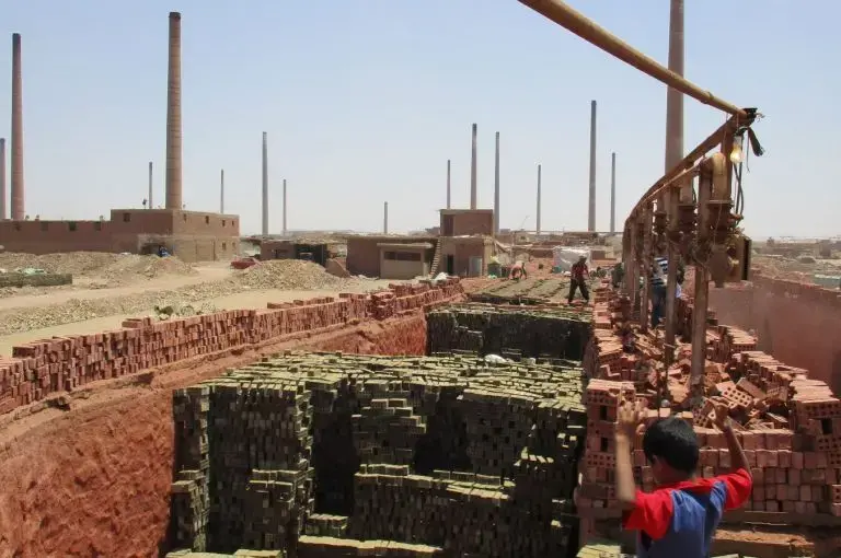 Laborers south of Cairo manufacture bricks to feed Egypt's construction industry. With currency pressures on commodities and real estate, this is one of a handful operating hundreds of factories. Image by Jahd Khalil. Egypt, 2016. Laborers south of Cairo manufacture bricks to feed Egypt's construction industry. With currency pressures on commodities and real estate, this is one of a handful operating hundreds of factories. Image by Jahd Khalil. Egypt, 2016.