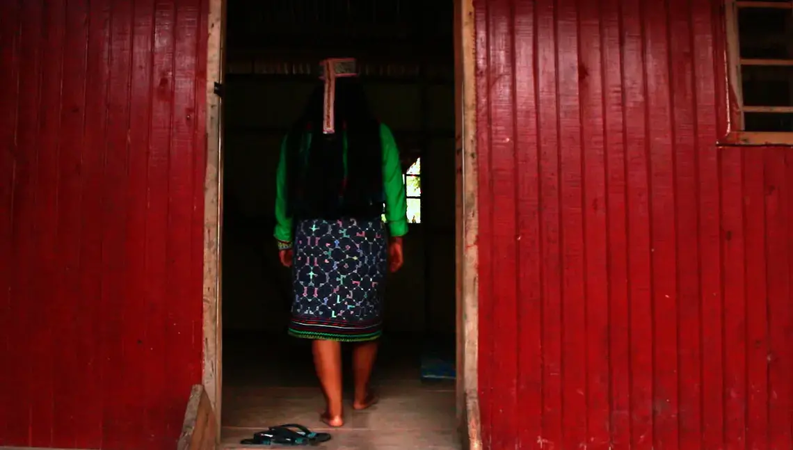Karina Garcia Ríos, who calls herself 'Mujer Medicina,' or medicine woman, walks into the ceremonial room in her home in Pucallpa. Image by Natalie Hutchison. Peru, 2017.