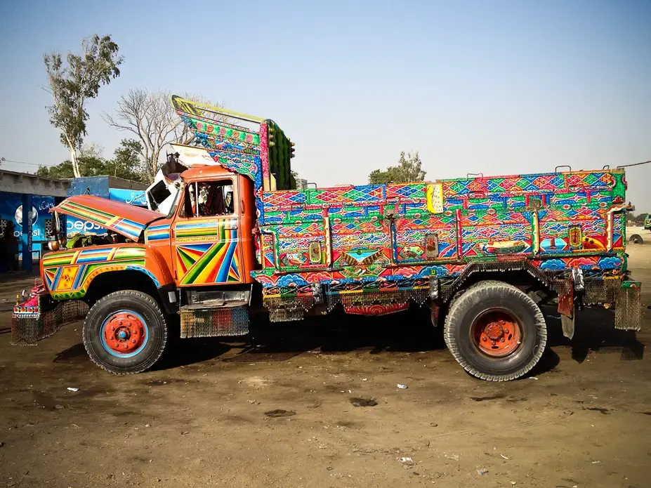 A dump truck on the outskirts of Karachi. The color scheme is linked to Sufi mysticism, which holds that the most vibrant colors are the purest. Image by Matthieu Aikins. Pakistan, 2013. Media file: TruckArt (3 of 16).jpg