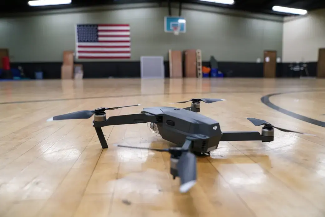 A Jeffersontown Police officer demonstrates flying the department’s DJI Mavic Pro drone in the police department gym. Image by J. Tyler Franklin. USA, 2019. A Jeffersontown Police officer demonstrates flying the department’s DJI Mavic Pro drone in the police department gym. Image by J. Tyler Franklin. USA, 2019.