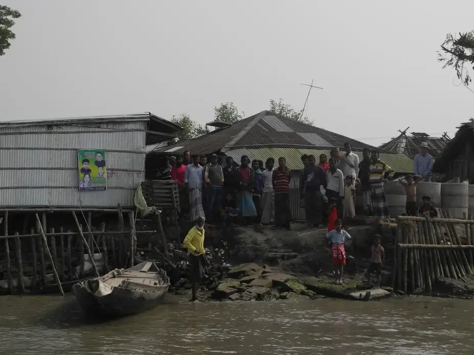 Residents stand at the edge of Polder 32 on the Bangladesh coast. The polder was inundated by Cyclone Aila in 2009. The flooding lasted two years, after the walls surrounding the polder were damaged. Now the walls are being rebuilt. But some scientists warn that's inviting another disaster. Residents of Polder 32 on the Bangladesh coast.