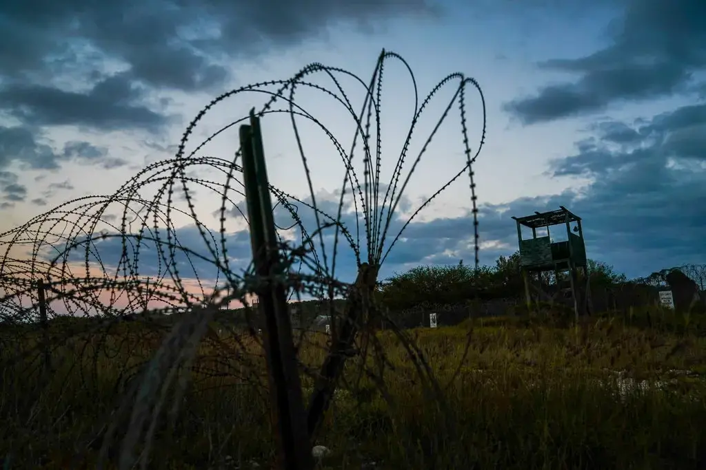 Mohammed al-Qahtani was brutally interrogated by the U.S. military at Camp X-Ray, above, a detention facility at Guantánamo Bay. Image by Doug Mills/The New York Times. Cuba, 2020. Mohammed al-Qahtani was brutally interrogated by the U.S. military at Camp X-Ray, above, a detention facility at Guantánamo Bay. Image by Doug Mills/The New York Times. Cuba, 2020.