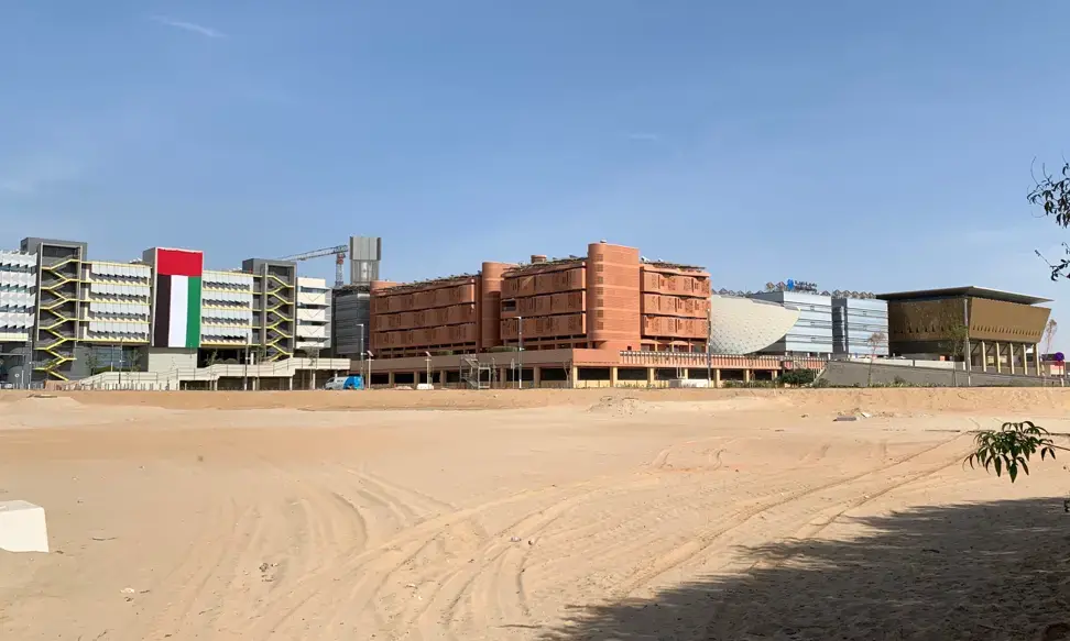 View from the road of Masdar City’s completed buildings. From left to right: Siemens Middle East Headquarters, Khalifa University Residential Building, Knowledge Centre, Multipurpose Khalifa University Building, and Multi-Use Hall. Image by Anna Gleason. United Arab Emirates, 2019. View from the road of Masdar City’s completed buildings. From left to right: Siemens Middle East Headquarters, Khalifa University Residential Building, Knowledge Centre, Multipurpose Khalifa University Building, and Multi-Use Hall. Image by Anna Gleason. United Arab Emirates, 2019.