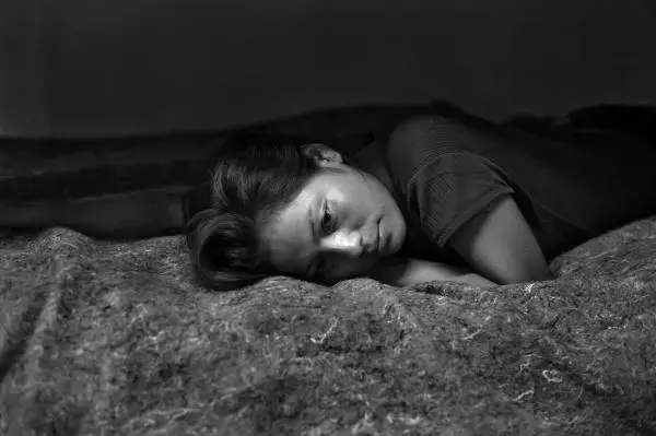 Second place in POYi's single portraits category: Marisol Espinoza, a 20-year-old woman from Chiapas, Mexico, in a shelter for deportees and migrants the night after she was deported from the United States. She crossed into the United States and walked through the Arizona desert for six days before she was arrested by the U.S. Border Patrol. Image by © Louie Palu/ZUMA. Mexico, 2012. Media file: yuma_nogales02.jpg
