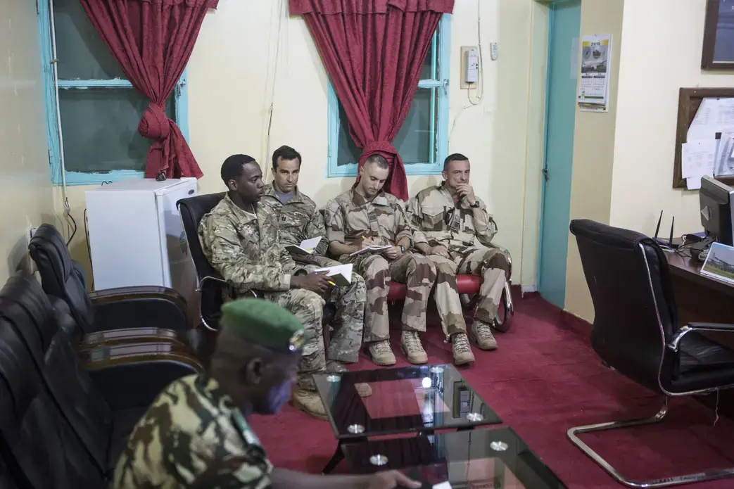 American and French soldiers, with a translator working for the American military, attend a daily briefing at a Nigerien military base in Diffa, Niger, March 26, 2015. Image by Joe Penney. Niger, 2015. American and French soldiers, with a translator working for the American military, attend a daily briefing at a Nigerien military base in Diffa, Niger, March 26, 2015. Image by Joe Penney. Niger, 2015.