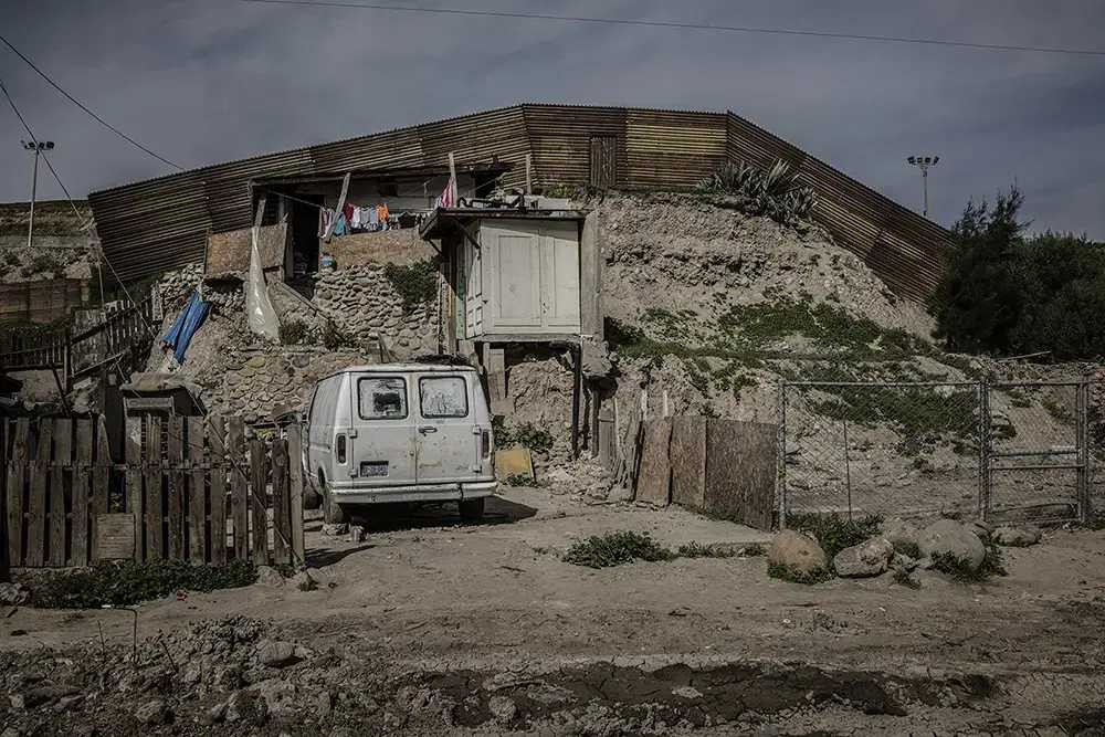 Makeshift House A makeshift house that sits right up against the border wall in Otay Canyon in Tijuana. Image by James Whitlow Delano. Mexico, 2017.