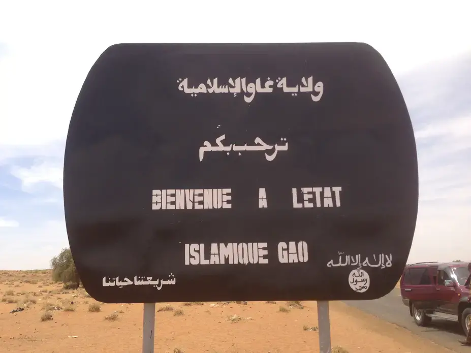 A sign erected by the Islamists on the main road to Gao, the
biggest city in the northern region of Mali. It reads "Welcome to the Islamic State of Gao." Image by Yochi Dreazen. Mali, 2013. Media file: Pulitzer.JPG