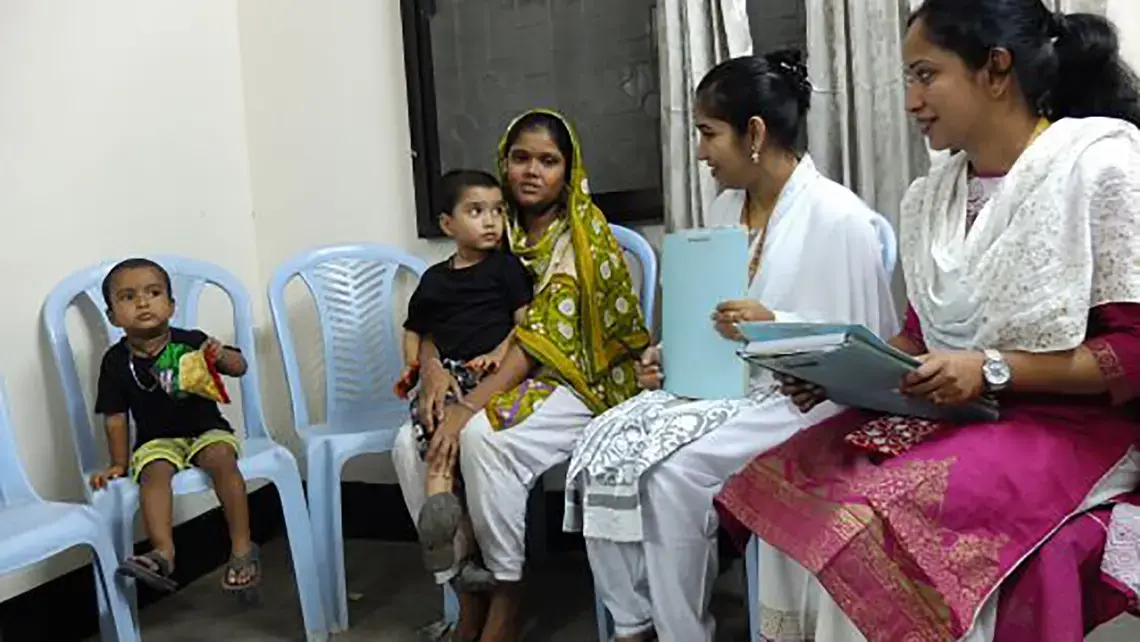 Mohommad Mustakim and his mother talk with researchers as part of a study of the rotavirus vaccine in Dhaka, Bangladesh. Mohommad got sick with rotavirus diarrhea even after getting the vaccine. Image by Carina Storr. Bangladesh, 2016. Media file: mohommad_and_family_1.jpg