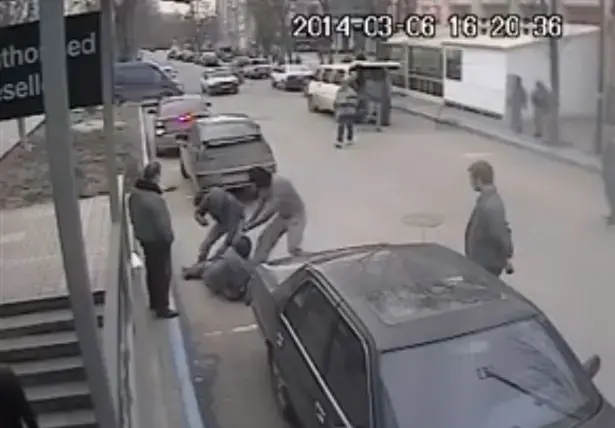 Security camera still of Dimiter Kenarov's attackers. Ukraine, 2014. Media file: crimea_cossack_attack_sg_img.jpg