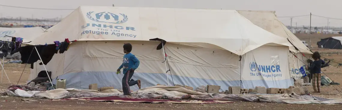 Poor Jordanian children play outside a tent Sunday, March 20, 2016 outside the Zaatari refugee camp in Jordan about 15 miles from the Syrian border. Some media outlets have mistakenly said Syrians were living in the tents. The handful of tents are used by poor Jordanians, who bought the tents from Syrians who lived in the camp. No one in the camp has lived in a tent for over a year after replacing all the housing with prefabricated metal structures. Image by Mark Hoffman. Jordan, 2016. Media file: jordan_for_day_camp_blog.jpg