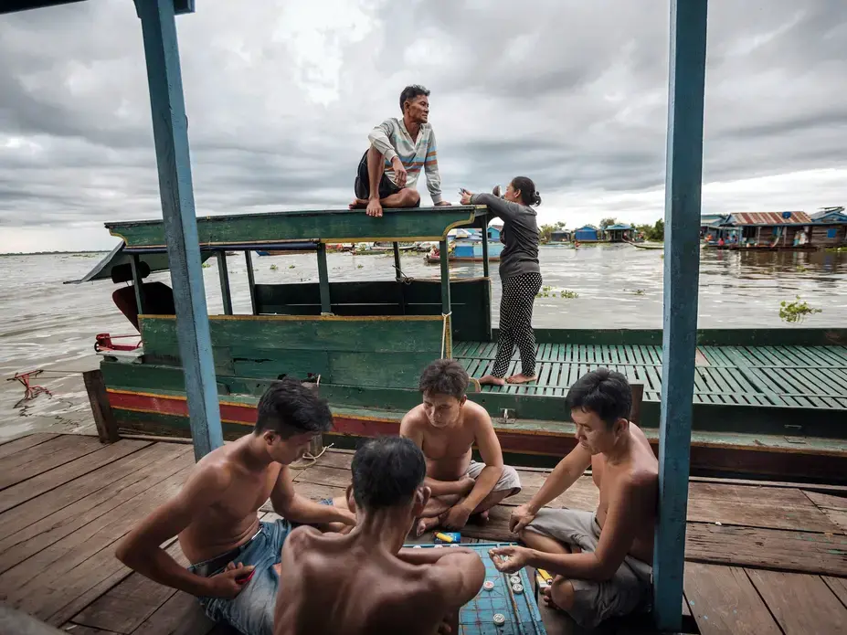 Playing xiangqi on the porch of a floating house in the village of Chhnok Trou. Image by Andrea Frazzetta. Cambodia, 2018. Playing xiangqi on the porch of a floating house in the village of Chhnok Trou. Image by Andrea Frazzetta. Cambodia, 2018.