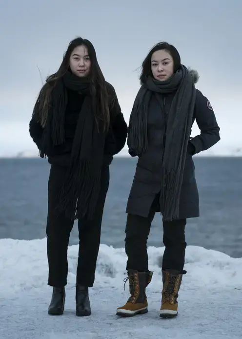 Twins Sara and Stina Olsvig, 16, twins from Greenland, are both planning to go to school in Denmark for a year, what is known in Denmark as "Efterskole."  their current classes, about half the students will go abroad after the summer break. The Greenlandic student association says that of students who go abroad, only about half return to Greenland afterwards to live. Sara says she wants to become and architect, while Stina wants to be an airline crew member. Image by Jonas Bendiksen. Greenland, 2018.