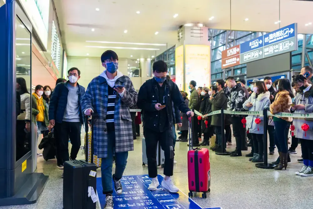 Chengdu, Sichuan, China: Travelers wear masks at the airport to prevent infection from coronavirus. Image by B.Zhou / Shutterstock. China, 2020. Chengdu, Sichuan, China: Travelers wear masks at the airport to prevent infection from coronavirus. Image by B.Zhou / Shutterstock. China, 2020.