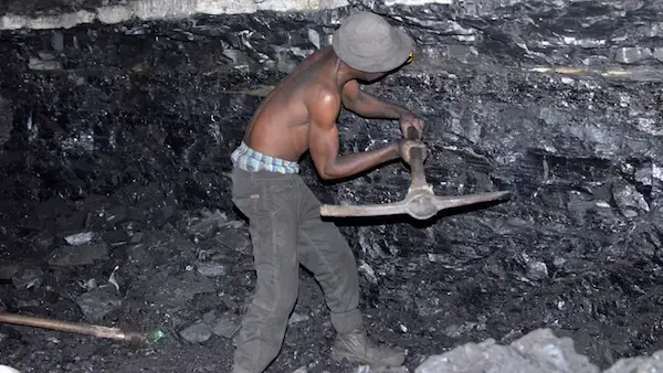 A small-scale miner illegally digs coal from an abandoned, former Anker Coal operation just outside Ermelo, Mpumalanga. Image by Mark Olalde. South Africa, 2017. A small-scale miner illegally digs coal from an abandoned, former Anker Coal operation just outside Ermelo, Mpumalanga. Image by Mark Olalde. South Africa, 2017.