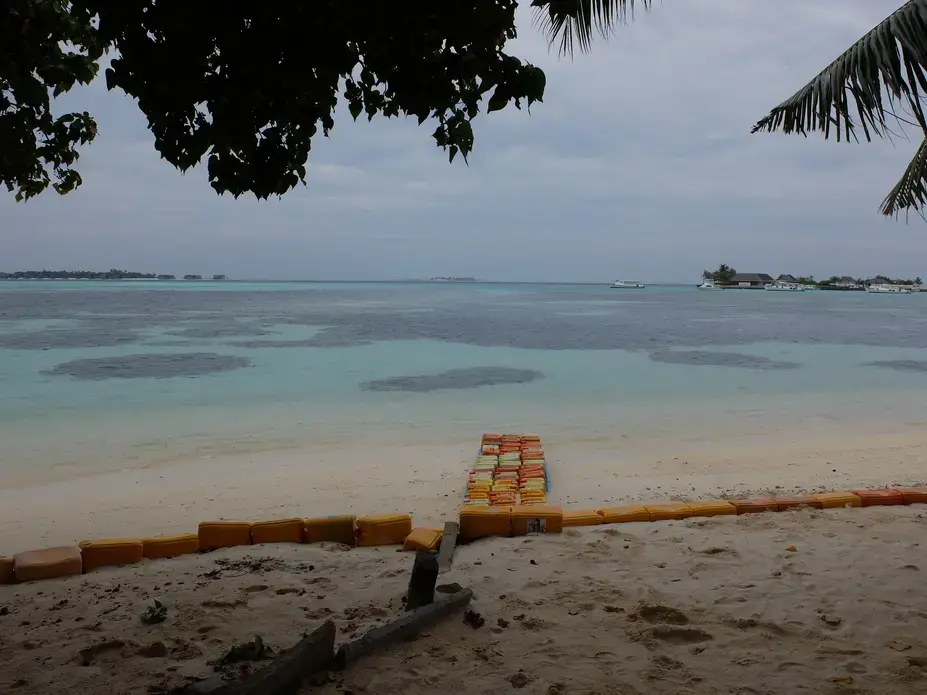Plastic jerrycans have been staked on the beach of Guraidhoo, Maldives, to protect the shoreline during storm surges. Image by Kai Schultz. Maldives, 2017. Plastic jerrycans have been staked on the beach of Guraidhoo, Maldives, to protect the shoreline during storm surges. Image by Kai Schultz. Maldives, 2017.